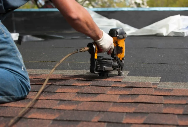 A man from a Bay Area residential roofing company is working on a shingled roof in San Francisco.
