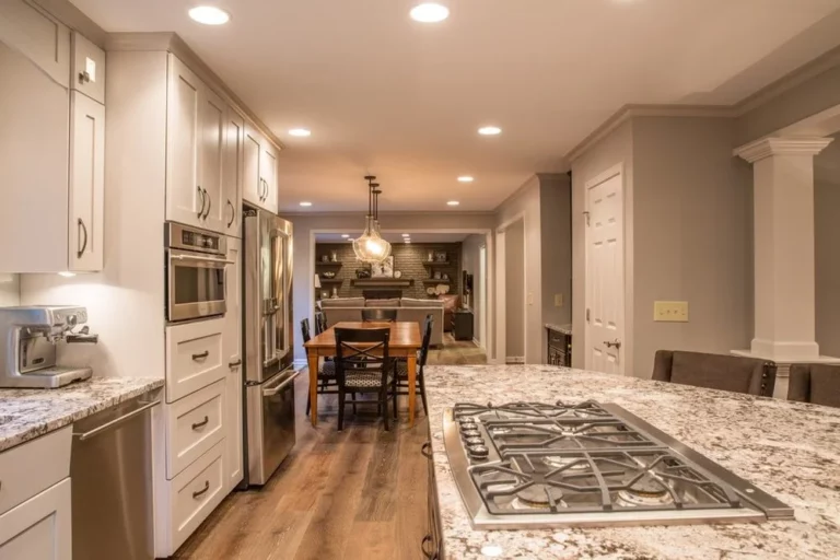 A kitchen with granite counter tops and stainless steel appliances.