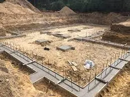 A foundation is being built in a wooded area .