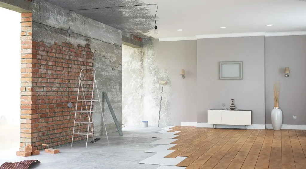 A room is being remodeled with wood floors and a brick wall in a home with a seismic retrofit.