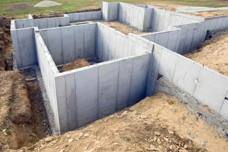 A multi-family dwelling foundation is being built with concrete walls.