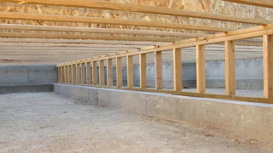 A basement with wooden beams and a wooden floor of a home with a seismic retrofit.