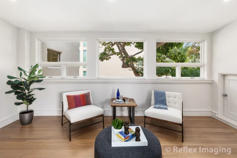 A living room with two chairs and a table.